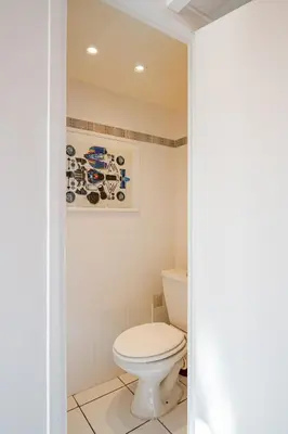 a bathroom with a white toilet in a room at Sunny duplex close to Croisette, free parking in Cannes