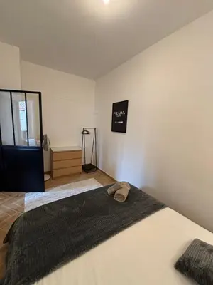 a bedroom with a bed with two slippers on it at HomeForville in Cannes
