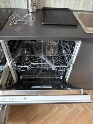a dishwasher with its door open in a kitchen at HomeForville in Cannes