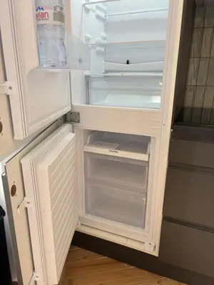 an empty refrigerator with its door open and its empty shelves at HomeForville in Cannes