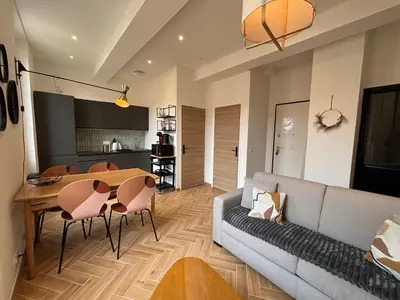 a living room with a couch and a table and chairs at HomeForville in Cannes