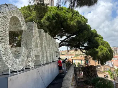 a person standing on a wall next to a tree at HomeForville in Cannes