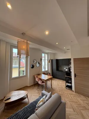 a living room with a couch and a table at HomeForville in Cannes