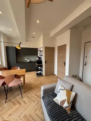 a living room with a couch and a table at HomeForville in Cannes