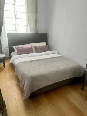 a bedroom with a bed and a table and a mirror at 3P Cannes Centre 2min Palais des Festivals,Rue du Antibe location in Cannes