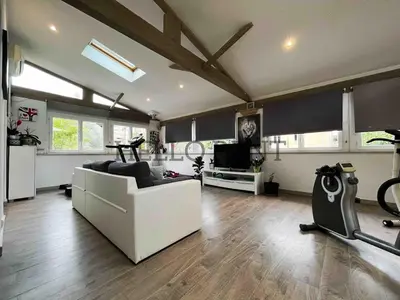 a living room with a white couch and a tv at Grande Villa Cannes Centre havre de paix in Cannes