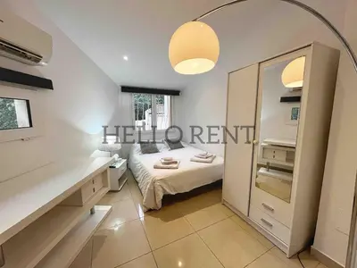 a bedroom with a bed and a large mirror at Grande Villa Cannes Centre havre de paix in Cannes