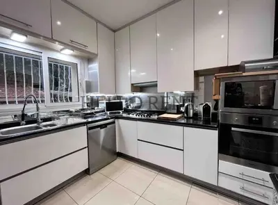 a kitchen with white cabinets and stainless steel appliances at Grande Villa Cannes Centre havre de paix in Cannes