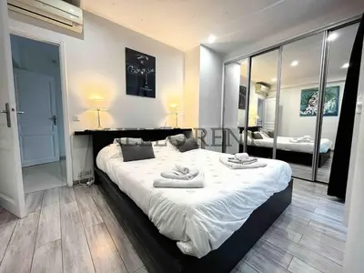 a bedroom with a large bed with towels on it at Grande Villa Cannes Centre havre de paix in Cannes