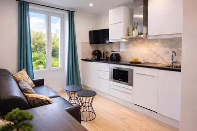 a living room with a couch and a table at Serenity in Cannes
