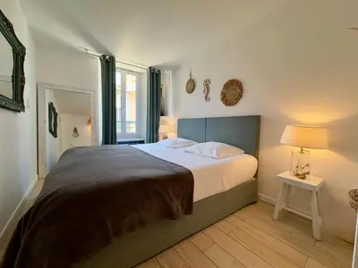 a bedroom with a large bed and a window at Tredici By SCLS Locations in Cannes