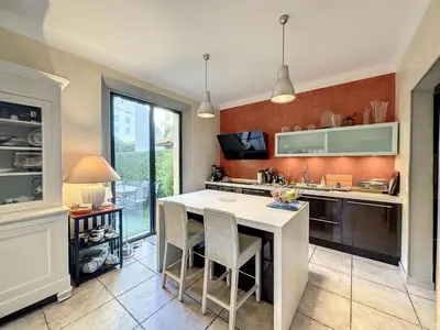 a kitchen with a white island in a room at 3-Bedroom house with terrace 5 minutes walking from La Croisette in Cannes