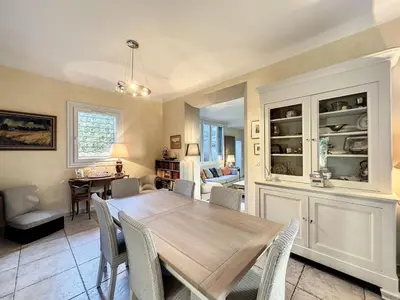 a dining room with a wooden table and chairs at 3-Bedroom house with terrace 5 minutes walking from La Croisette in Cannes