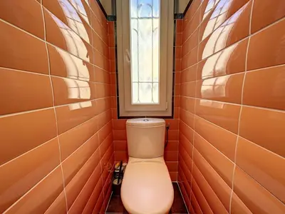 a bathroom with a toilet with a window at 3-Bedroom house with terrace 5 minutes walking from La Croisette in Cannes