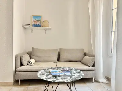 a living room with a couch and a table at Cannes 2 Bedroom Apartment - 19JDR2 in Cannes