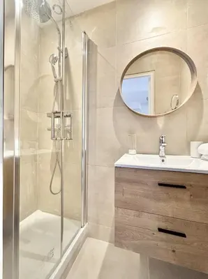 a bathroom with a shower and a sink and a mirror at Cannes 2 Bedroom Apartment - 19JDR2 in Cannes