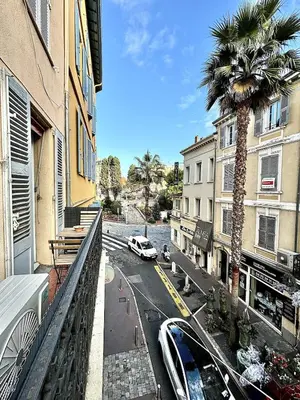 a view of a city street with a palm tree on a balcony at Cannes 2 Bedroom Apartment - 19JDR2 in Cannes