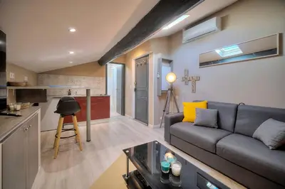 a living room with a couch and a kitchen at Studio Cannes in Cannes