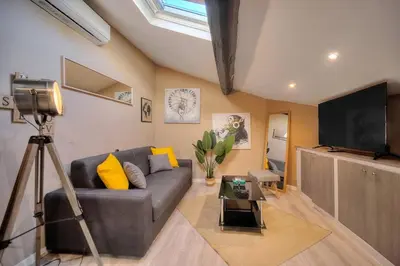 a living room with a couch and a flat screen tv at Studio Cannes in Cannes