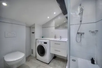 a bathroom with a washing machine and a toilet at Studio Cannes in Cannes
