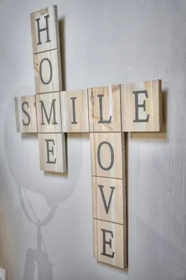 a wooden cross with the word kindness on a wall at Studio Cannes in Cannes