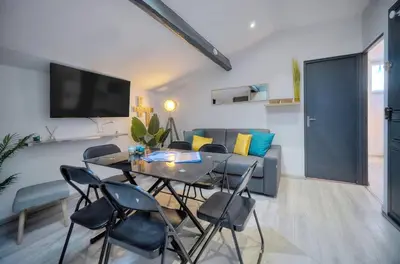 a living room with a table and chairs and a couch at Le 8 - Cannes in Cannes