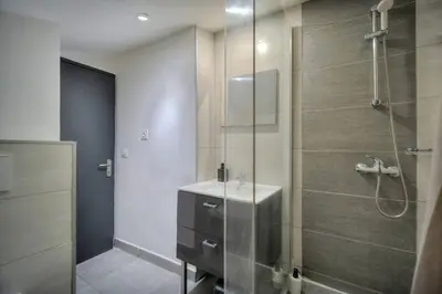 a bathroom with a glass shower with a sink at Le 8 - Cannes in Cannes