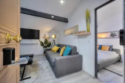 a living room with a couch and a bed at Le 8 - Cannes in Cannes