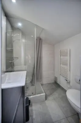 a bathroom with a shower and a sink and a toilet at Le 8 - Cannes in Cannes