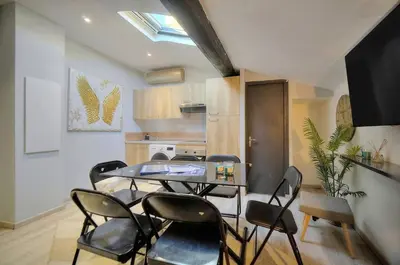 a dining room with a glass table and chairs at Le 8 - Cannes in Cannes