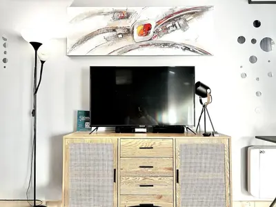 a tv on a dresser in a living room at Cannes 1 Bedroom Apartment - CC1 in Cannes