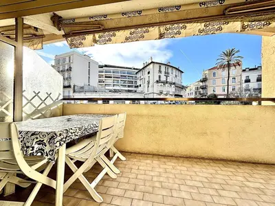 a table and chairs on a balcony with a view of a city at Cannes 1 Bedroom Apartment - CC1 in Cannes