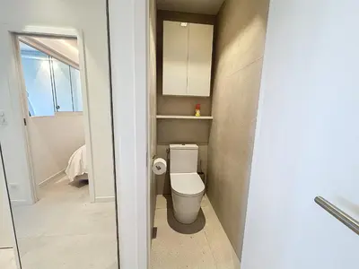 a small bathroom with a toilet and a window at 39m2 Croisette, terrasse, vue mer, garage in Cannes