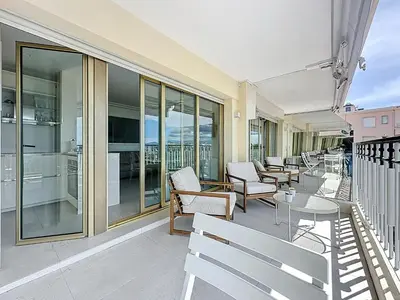 a balcony with chairs and tables on a building at 39m2 Croisette, terrasse, vue mer, garage in Cannes