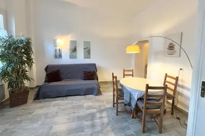 a room with a bed and a table and chairs at Luminous T2 on the seafront in Cannes