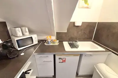a small kitchen with a sink and a microwave at Luminous T2 on the seafront in Cannes