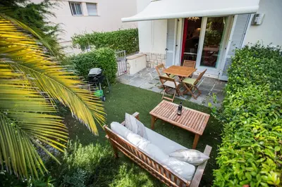 a patio with a couch and a table and a table at Résidence Les Palmiers by Connexion in Cannes