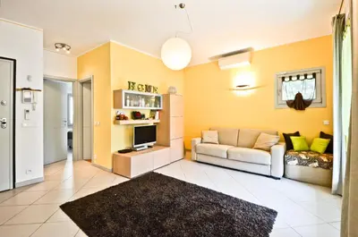 a living room with a couch and a tv at Résidence Les Palmiers by Connexion in Cannes