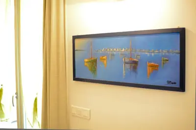 a painting of boats hanging on a wall at Résidence Les Palmiers by Connexion in Cannes