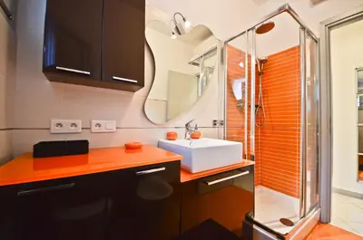 a bathroom with a sink and a mirror at Résidence Les Palmiers by Connexion in Cannes