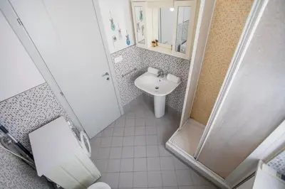 a small bathroom with a sink and a shower at Résidence Les Palmiers by Connexion in Cannes