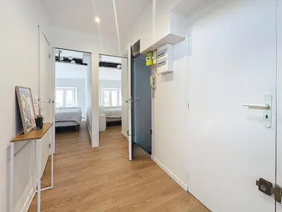 a room with a hallway with a door and a bedroom at 54m2 hypercenter, face Palais des Festivals in Cannes