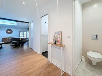 a bathroom with a toilet and a dining room at 54m2 hypercenter, face Palais des Festivals in Cannes