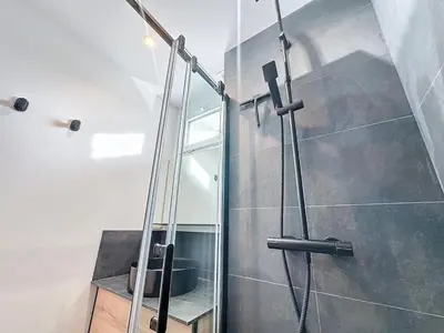 a shower with a glass door in a bathroom at 54m2 hypercenter, face Palais des Festivals in Cannes