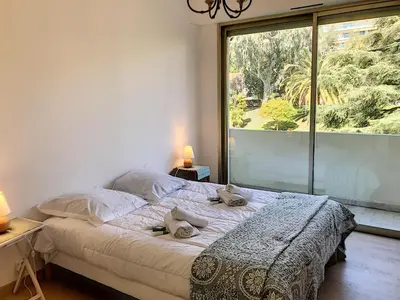 a bedroom with a bed and a large window at Bord de mer, terrasse vue mer 228L in Cannes