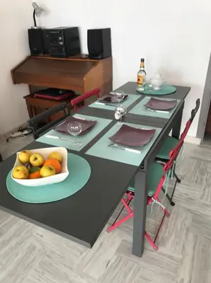 a black table with a bowl of fruit on it at Bord de mer, terrasse vue mer 228L in Cannes