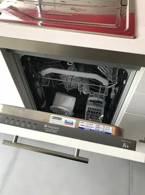 a dishwasher with its door open with the dishes inside at Bord de mer, terrasse vue mer 228L in Cannes
