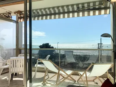 a balcony with chairs and a view of the ocean at Bord de mer, terrasse vue mer 228L in Cannes