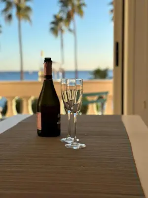 a bottle of wine and a wine glass on a table at Residence Palais Miramar in Cannes