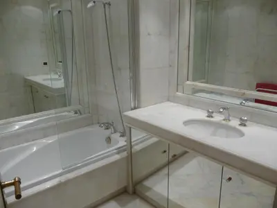 a bathroom with a sink and a shower and a tub at Residence Palais Miramar in Cannes
